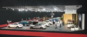 Auf der Messe Vienna Auto Show 2018 sind mehrere BMW Modelle unter hellen Lichtern ausgestellt, und die Menschen gehen umher, um die Fahrzeuge zu beobachten.