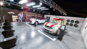 In einem Präsentations- und Schulungsraum stehen zwei MINI John Cooper Works Fahrzeuge. Die Wände sind mit Teilen und Felgen geschmückt. Vor den MINI Fahrzeugen stehen zwei Männer in Businessanzügen. Im Vordergrund stehen schwarze Stühle.